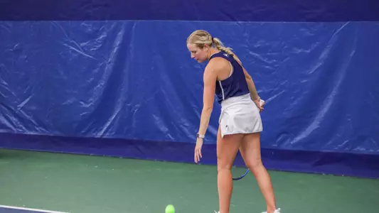 Carly Cohen about to serve the ball