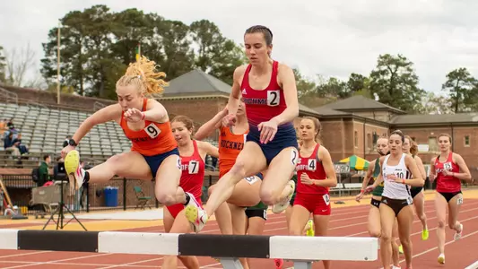 Elizabeth Stockman competing in the 3K steeplechase, about to jump into the water