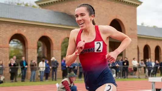 Elizabeth Stockman smiling after jumping over the hurdle in the steeplechase