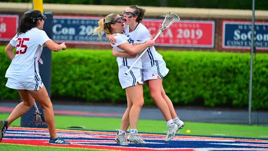 Marymargaret Quinn jumping into Alexis Mortons arms with excitement after she scored a goal