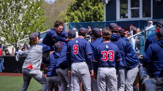 Connor Larson jumps onto his teammates arms to celebrate his home run