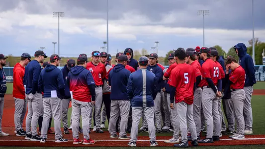 Baseball head coach Mik Aoki addresses the team after the Sunday game at URI