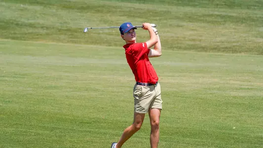 Drew Carlin holds his follow through after hitting an iron shot from the fairway