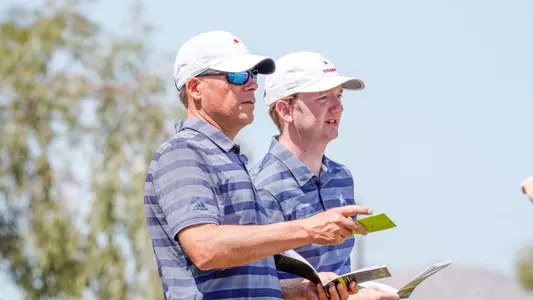Adam Decker and Patrick Isztwan converse on the tee box