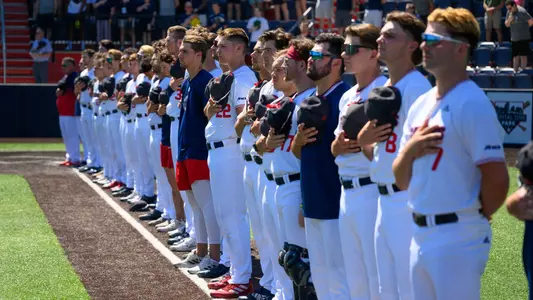 The baseball team stand for the National Anthem