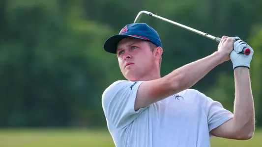 Lou Baker holds his follow-through and watches his approach shot to the green