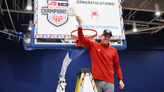 Aaron Roussell twirls the net after cutting it down following Richmond's win in the A-10 Championship game.