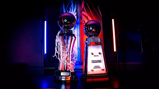 Photo of the regular season and tournament championship women's basketball trophies