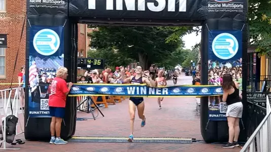 Madison Trippett crossing the finish line in first place at the 2024 Collegiate Road Mile National Championship