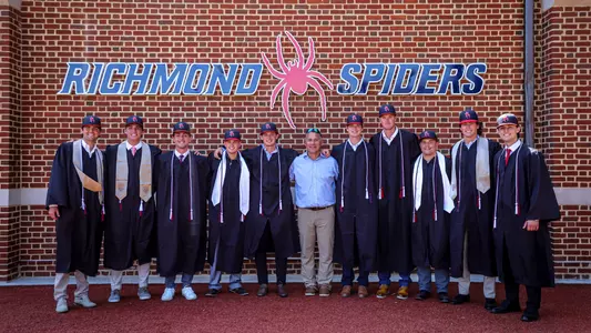 Members of Spider baseball graduating in 2024 pose in their caps and gowns with coach Mik Aoki