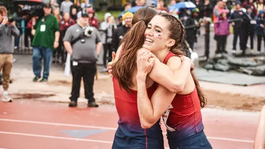 Madison Trippett and Elizabeth Stockman embracing a hug after the 1500 meter race at the 2024 Atlantic 10 Outdoor Championships