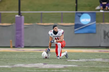 Nick DeGennaro kneeling on the field at Casey Stadium in Albany, N.Y. during the Second Round of the 2023 NCAA Playoffs