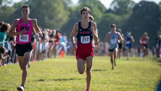 Henry Haase sprints across a field at the Spider Alumni Open