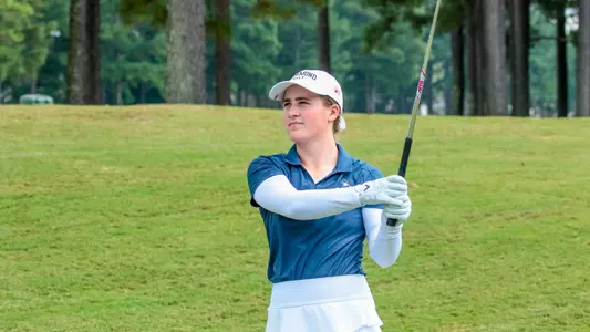 Caroline Thompson holds a high follow through after hitting her approach shot