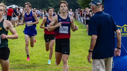 William Marhold sprints across the finish line at the end of his XC race