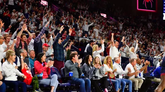 Fans react to a Spiders three-pointer vs Dayton
