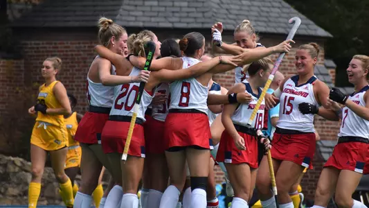 Spider field hockey celebrates the overtime victory against Towson at Crenshaw Field