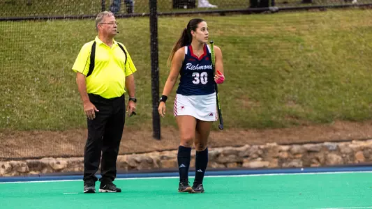 Spider field hockey's Valen Luna Paratore stands next to an official