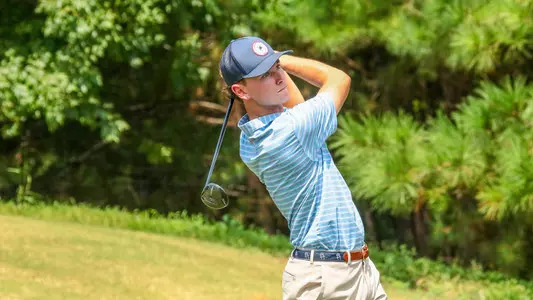 Drew Carlin holds his follow through on the tee box