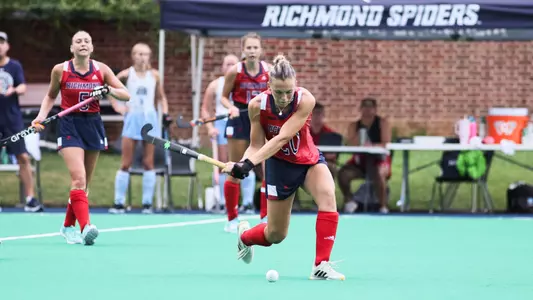 Spider field hockey's number 20 Clara Larripa swings her stick and connects with the ball