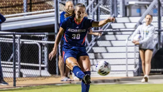 Abby Dillon kicking the ball in the game against William & Mary