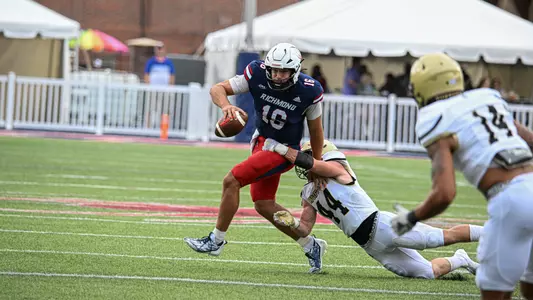 Kyle Wickersham runs the ball and tries to evade a Wofford defender during Richmond's home opener loss to the Terriers Sept. 7, 2024