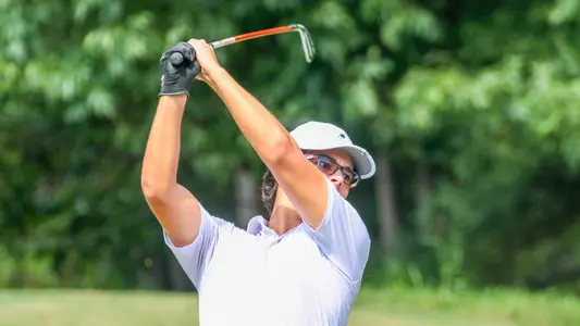 Carson Baez holds his follow through high above his head