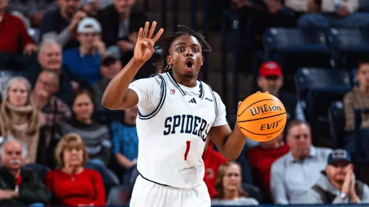 Mikkel Tyne calls out the offense while bringing the ball up the court
