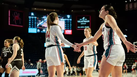 Maggie Doogan and Rachel Ullstrom high fiving