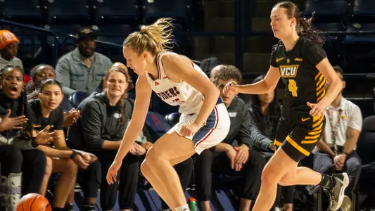 Katie Hill dribbling around a VCU player
