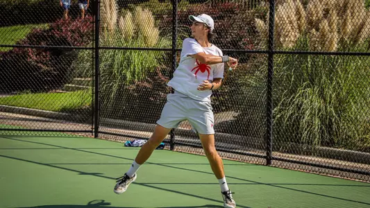 Otto Sewell returning a serve