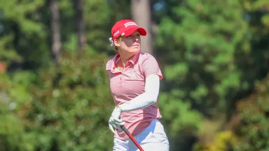Olivia Wilkie stares down her tee shot as she walks off the tee box