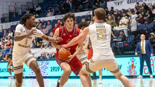 Ryan Soulis dribbles into a crowd at GW