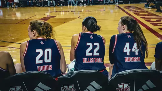 Photo of Addie Maggie and Rachel on the bench at a timeout