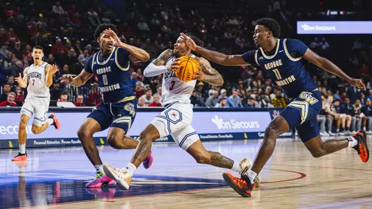 DeLonnie Hunt drives to the basket through two defenders