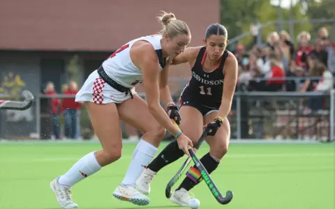 Spider field hockey's Grace Wiggins drives past her Davidson defender