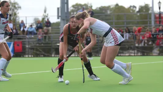 Spider field hockey's Emma Williams drives past her Davidson defender