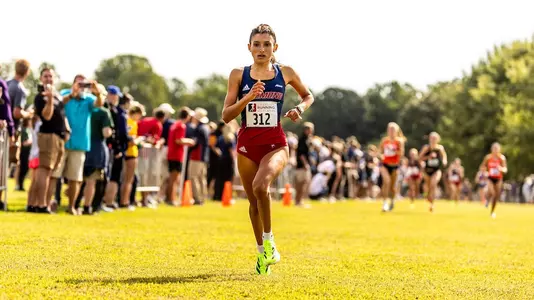 Hallie Muniz crossing finish line at 2025 Spider Alumni Open