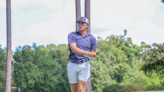 Parker Moellinger holds his follow through after his tee shot