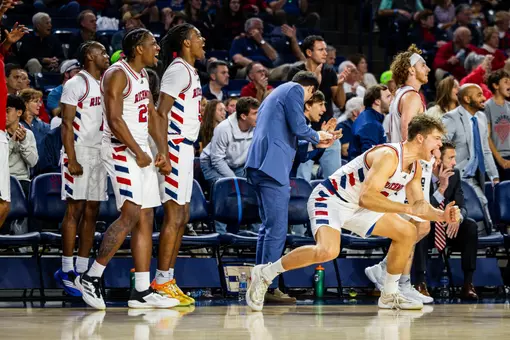 Mike Walz leaps off the bench to offer encouragement