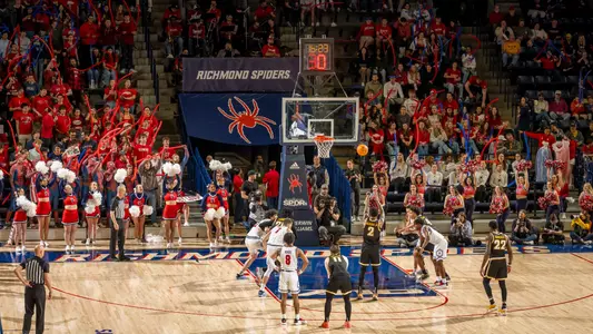 An opposing player shoots a free throw at the Robins Center