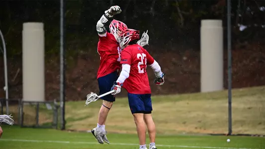 Gavin Creo and Lucas Littlejohn celebrate a goal during Richmond's 13-10 win over Virginia on Feb. 15, 2025