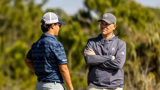 Carson Baez and Adam Decker chat during a round