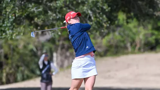 Olivia Wilkie holds her follow-through after her tee shot