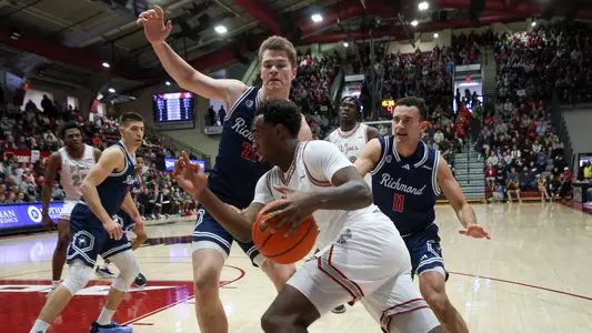 Mike Walz and Jason Roche defend a SJU player on the baseline