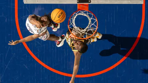Looking down as Mikkel Tyne spins in a layup vs VCU