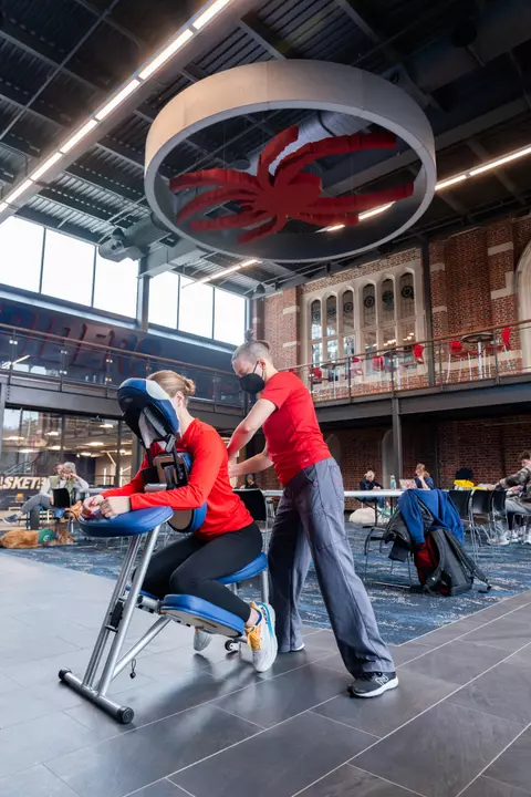 A woman receives a massage in Spider Hall