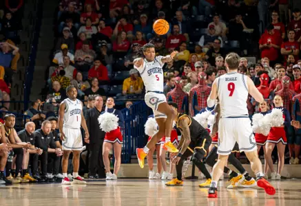 Collin Tanner throws an overhead pass vs VCU