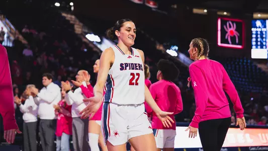 Rachel Ullstrom running through a handshake tunnel pregame