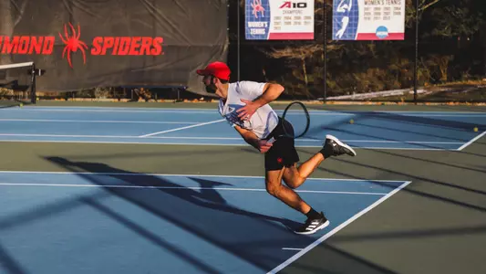 Cole Brashear serving the tennis ball